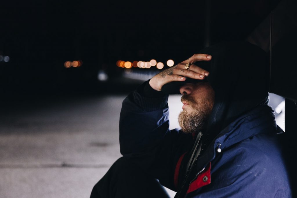 Homeless man, head in his hands