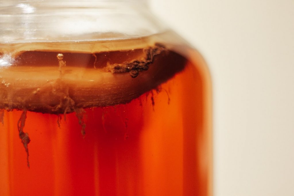 orange drink fermenting in a jar