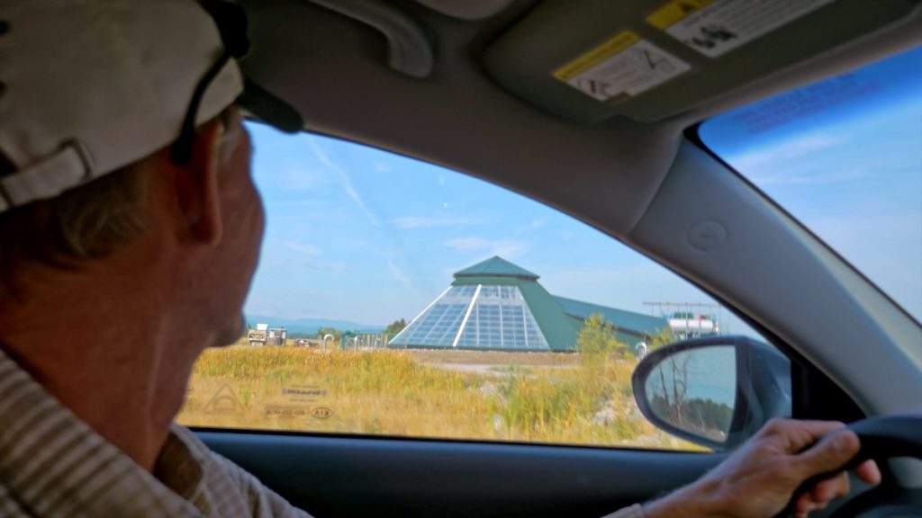 Man in car, dome shaped building