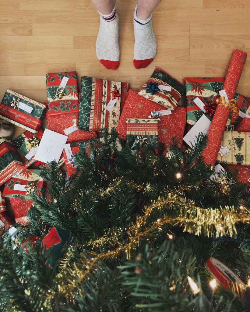 Christmas presents under a tree, a pair of feet