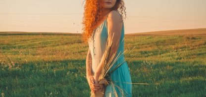 woman in blue dress in field