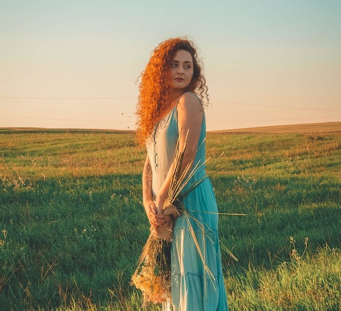 woman in blue dress in field