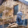 Home insulation being added to a side wall