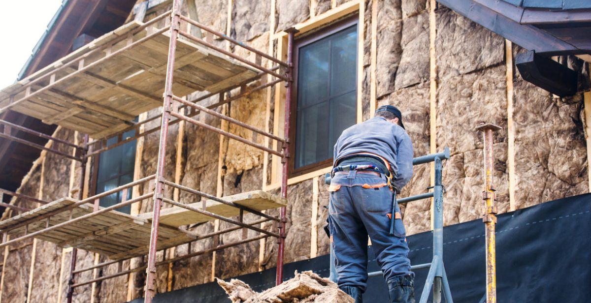 Home insulation being added to a side wall