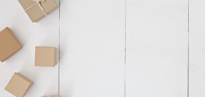 small, paper-wrapped gift on a white table
