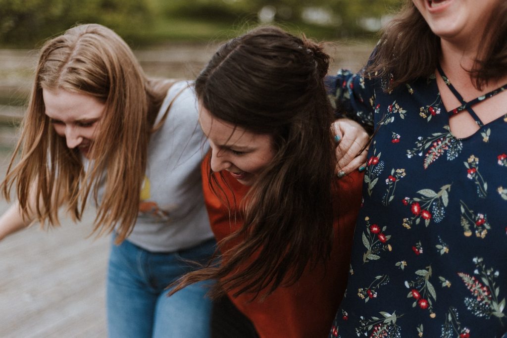 Three young women hugging