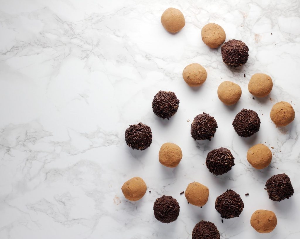 Chocolate truffles on a white surface