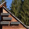 Solar panel on the front of a wood panelled house