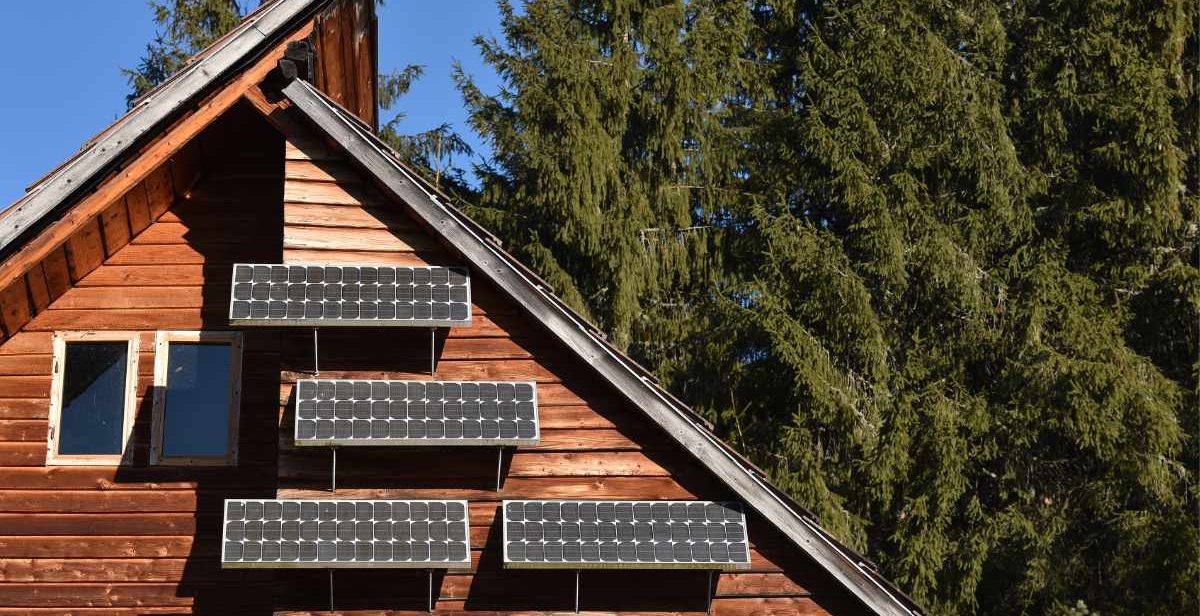 Solar panel on the front of a wood panelled house