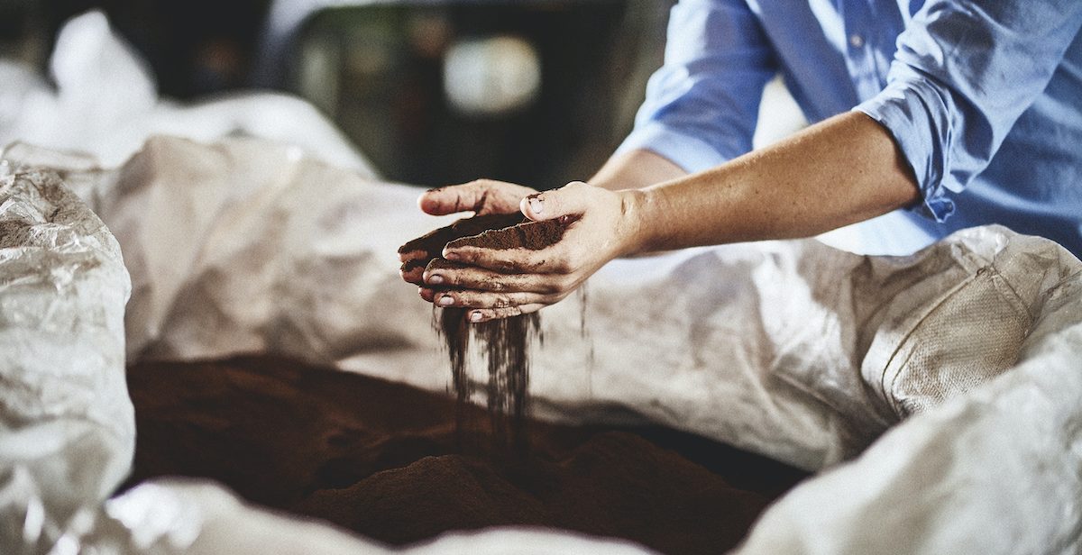 hands holding dried coffee waste