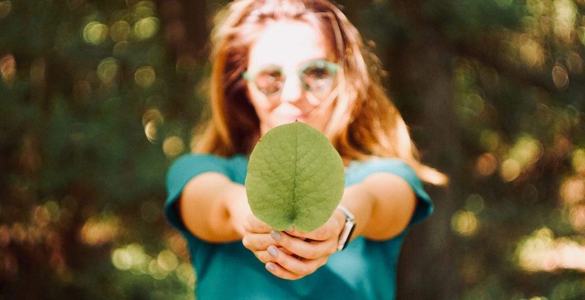 Woman holding leaf
